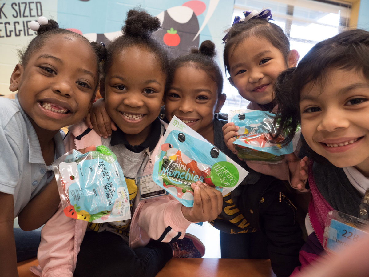 Group of kids holding Mini Munchies® snacks